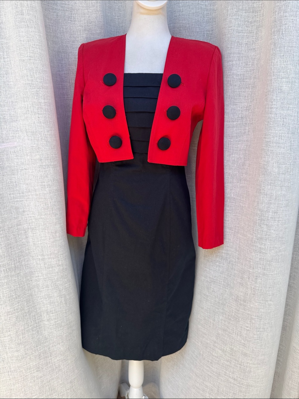 Jillian Arthur 1990s black strapless dress paired with a red bolero crop blazer